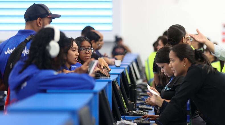 Passengers check in at Simon Bolivar International Airport as it reopens to commercial flights two months after closing due to the earthquake in Maiquetia, Venezuela, Tuesday, Sept. 1, 2026. (AP Photo/Pedro Mattey)