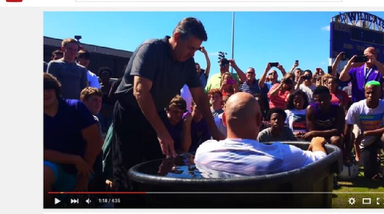 According to reports, several members of the Villa Rica High School football team were baptized on-field before practice. (Credit: 11Alive via YouTube)