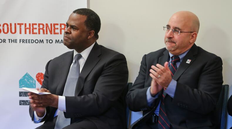 Atlanta Mayor Kasim Reed (left) and Evan Wolfson, founder and president of Freedom To Marry applaud during the program Monday.