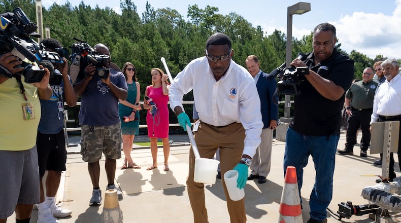Fulton County Lab Manager Patrick Person takes a sample of sewage at the Camp Creek Water Reclamation Facility on Tuesday morning, July 26, 2022. The sample is used to test for COVID-19 and monkeypox infections in the community. (Ben Gray for the Atlanta Journal-Constitution)