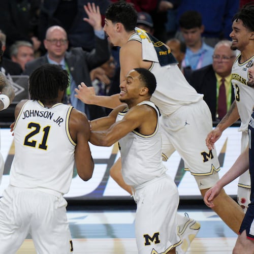 Michigan celebrates after defeating UConn in the NCAA college basketball tournament national championship game at the Final Four, Monday, April 6, 2026, in Indianapolis. (AP Photo/AJ Mast)