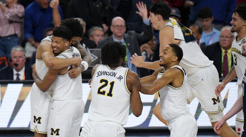 Michigan celebrates after defeating UConn in the NCAA college basketball tournament national championship game at the Final Four, Monday, April 6, 2026, in Indianapolis. (AP Photo/AJ Mast)