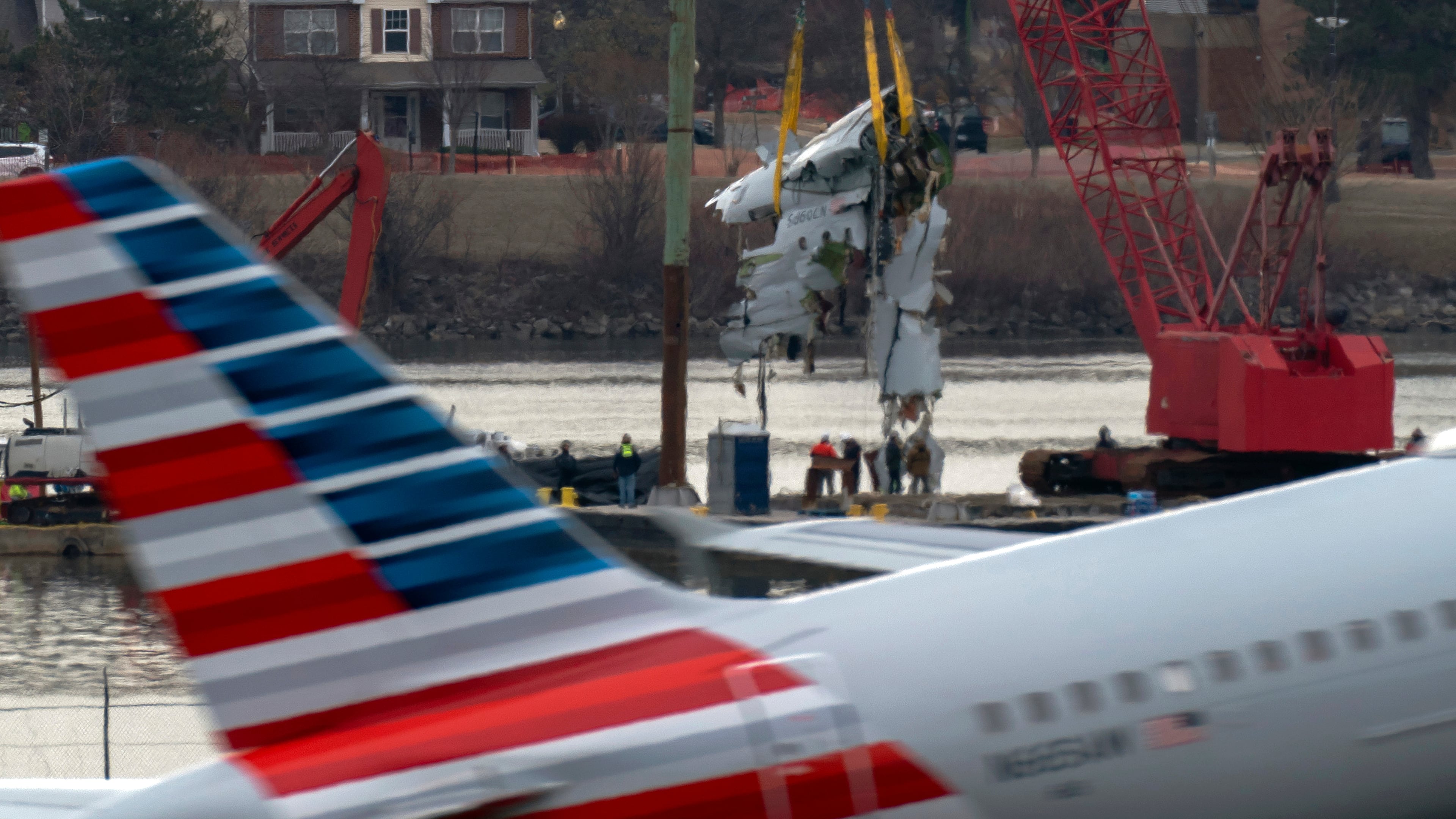 FILE - Crews pull up a part of a plane from the Potomac River near Ronald Reagan Washington National Airport, Monday, Feb. 3, 2025, in Arlington, Va. (AP Photo/Jose Luis Magana, file)