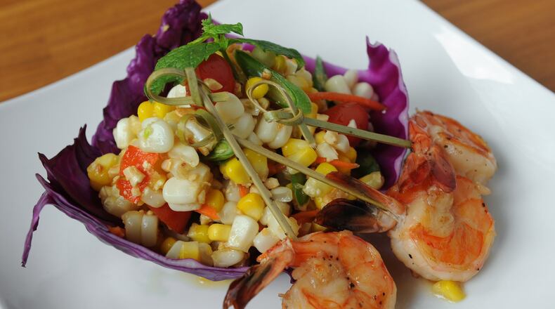 Corn Salad with white and yellow corn, cherry tomatoes, peanuts and green chili tossed in traditional Thai dressing and served with grilled shrimp. (BECKY STEIN PHOTOGRAPHY)