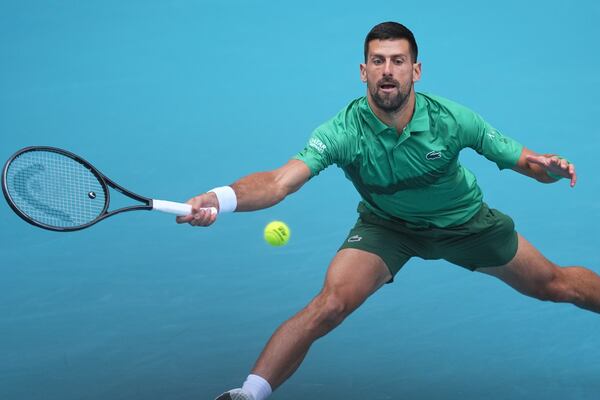 Novak Djokovic, of Serbia, plays a shot in his semifinal match against Grigor Dimitrov, of Bulgaria, at the Miami Open tennis tournament, Friday, March 28, 2025, in Miami Gardens, Fla. (AP Photo/Rebecca Blackwell)