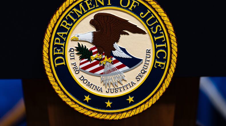 FILE - The U.S. Department of Justice logo is seen on a podium before a news conference, May 4, 2026, in Washington. (AP Photo/Julia Demaree Nikhinson, File)