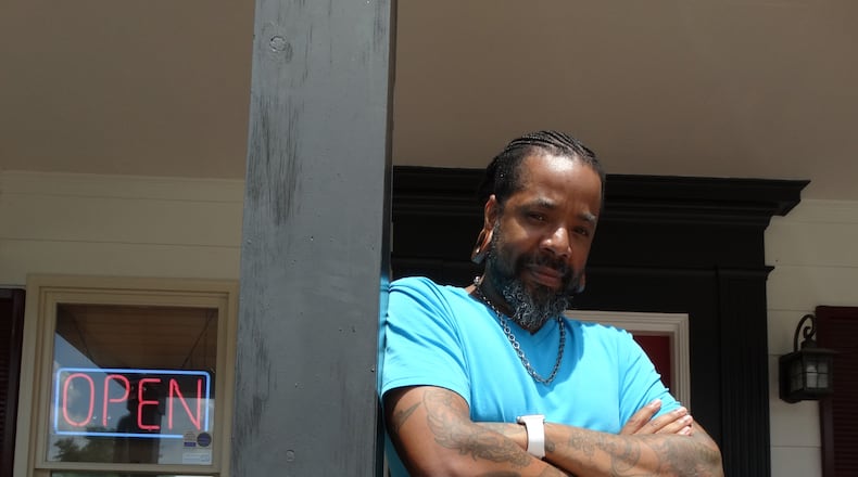 Craig Foster in the entrance of his Carrollton Inkwerks Tattoo & Design in June, 2015. CREDIT: Rodney Ho/rho@ajc.com