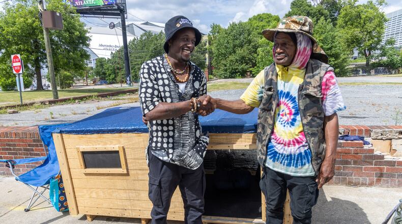 Brandon Brando (left) talks with Reginald Driskell, a man living in southwest Atlanta whom he befriended. He constructed a 7-by-3-foot wooden structure for Driskell, to get him out of an old cardboard box he had been living in. Brando would like to do that for others, as well.
PHIL SKINNER FOR THE ATLANTA JOURNAL-CONSTITUTION.