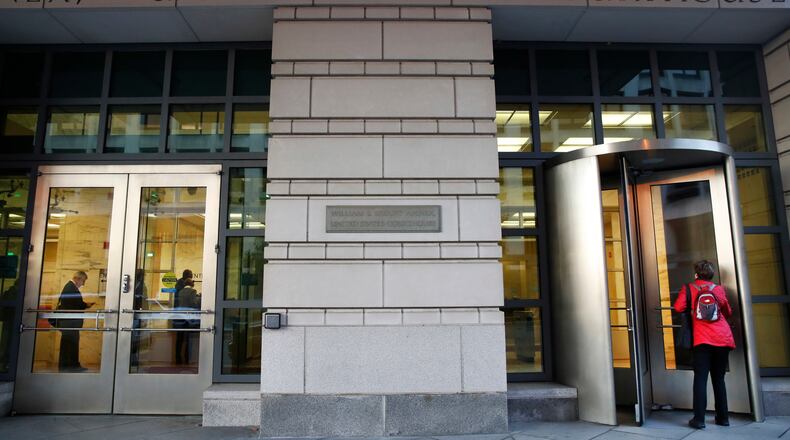 People enter the Federal Court on Monday in Washington. President Donald Trump's former campaign chairman, Paul Manafort, and a former business associate, Rick Gates, have been told to surrender to federal authorities. AP/Jacquelyn Martin