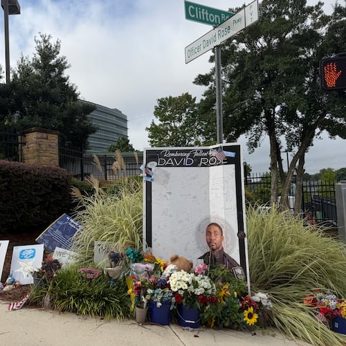 A sign displayed Friday, Aug. 7, 2026, outside the Centers for Disease Control and Prevention in Atlanta commemorates DeKalb County Police Officer David Rose, killed in a shooting a year ago. (Sara Gregory/AJC)