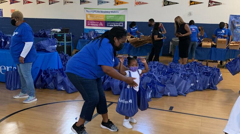 Anthem Blue Cross and Blue Shield has launched a local Partnership with Heart of America and iHeartMedia to impact food insecurity at College Park Elementary School. A room in the school will be converted to a permanent food pantry and on-site monthly food distributions will increase healthy food access for students and families. Pictured here, Anthem volunteers distribute food to College Park Elementary School students as part of a new food pantry program to address food insecurity for Atlanta area students and their families. (Photo: Business Wire)