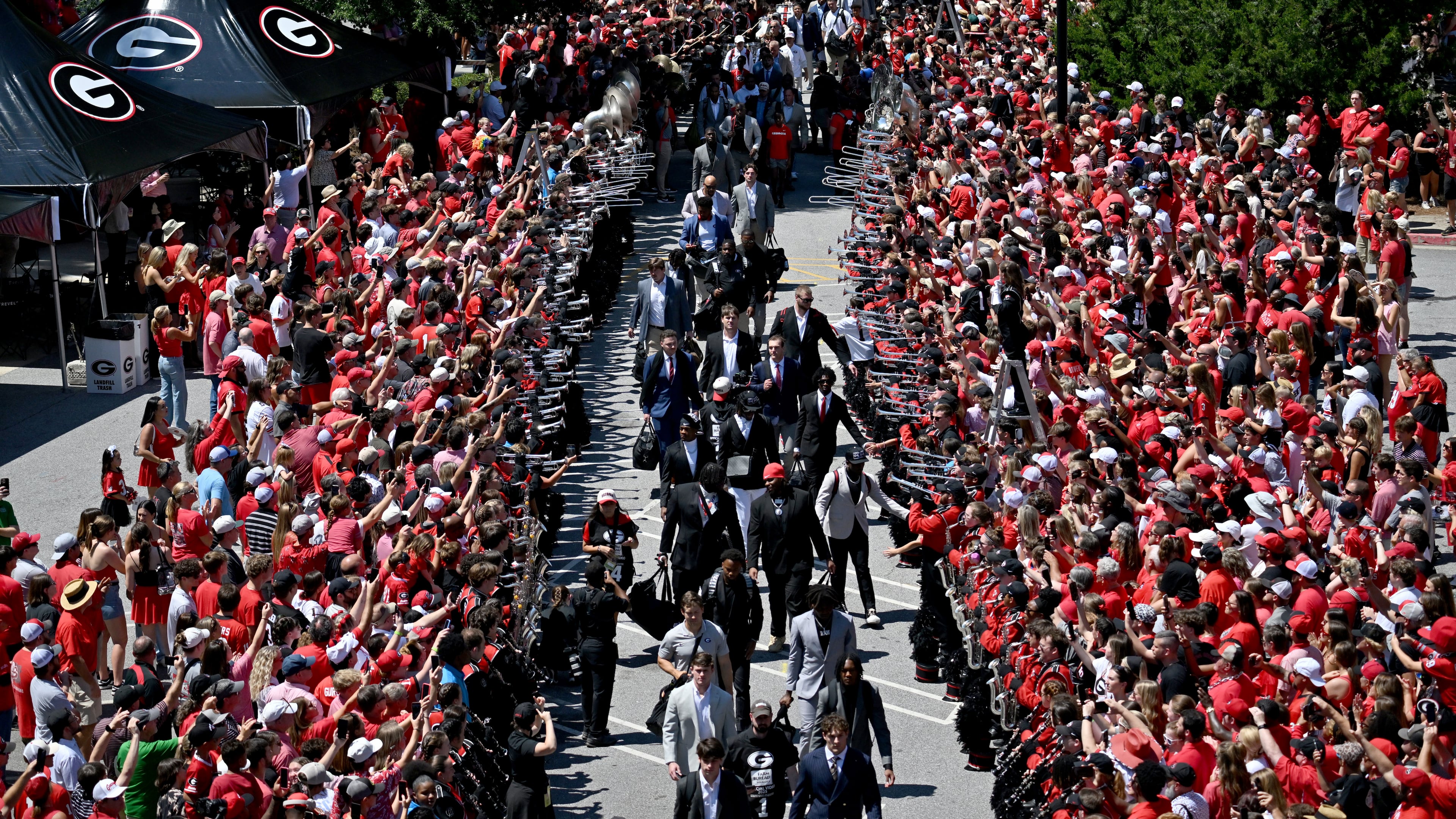 Georgia fans cheer as players and staff arrive during Dawgs Walk before Georgia football's season and home opener against Marshall at Sanford Stadium, Saturday, August 30, 2025, in Athens. (Hyosub Shin/AJC)