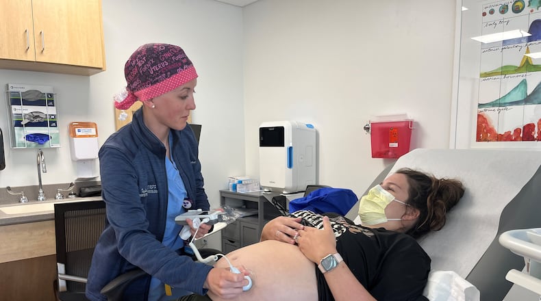 Obstetrician and gynecologist Taylar Swartz uses an ultrasound scanner to check the health of Addie Comegys’ baby on May 30, 2024. Comegys, who was seven months pregnant, had traveled 45 minutes for her prenatal appointment at Mahaska Health in Oskaloosa, one of a few rural hospitals in Iowa still offering labor and delivery services. (Tony Leys/KFF Health News/TNS)