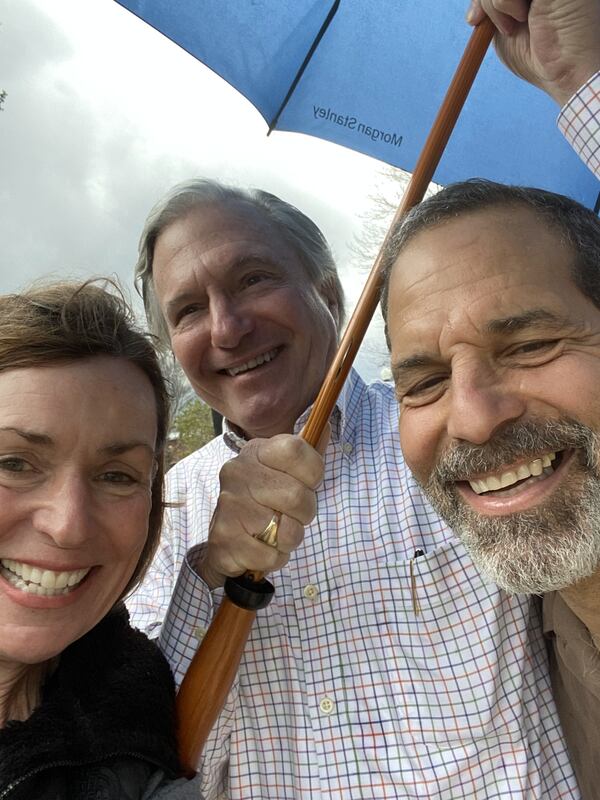 Anne Trulock, her husband, Robert, and UPS driver and delivery man Randy Pace last Friday during an impromptu and wet farewell ceremony for Pace at Madison’s Town Park. (Handout)