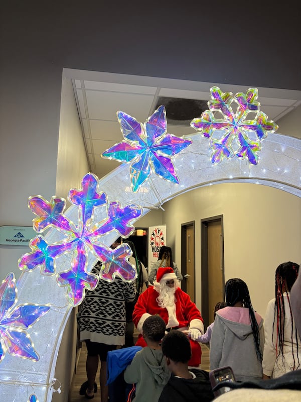 Families line up to take photos with Santa during Hosea Helps’ yearly Children’s Christmas Party on Saturday, Dec. 20, 2025. (Morayo Ogunbayo/AJC)