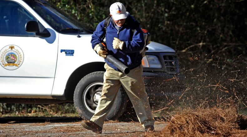 Duluth Parks and Recreation park supervisor Mike Morrow blows leaves and pine straw at the city's Rogers Bridge Park in late January, 2020. Prior to the pandemic, the city partnered with Gwinnett for inmate labor to assist with these tasks. (AJC FIle Photo by Bita Honarvar)
