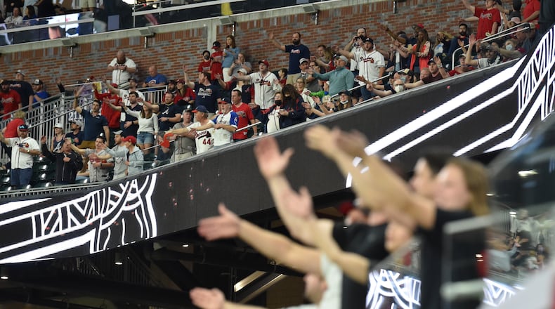 April 9, 2021 Atlanta - Atlanta Braves fans perform the "Tomahawk Chop" during Atlanta Braves homeopener game at Truist Park on Friday, April 9, 2021. Atlanta Braves won 8-1 over Philadelphia Phillies. (Hyosub Shin / Hyosub.Shin@ajc.com)