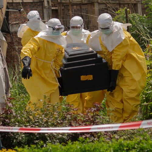 A woman cries as Red Cross workers carry the coffin of a person who died of Ebola from a health center in Rwampara, Congo, Wednesday, May 20, 2026. (AP Photo/Moses Sawasawa)