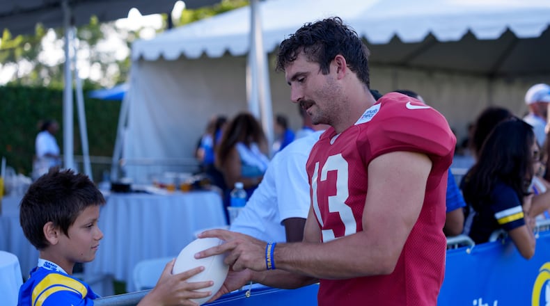Los Angeles Rams quarterback Stetson Bennett IV (13) interacts with fans after training camp on Friday, July 31, 2026, in Los Angeles. (Miya Tanner via AP)