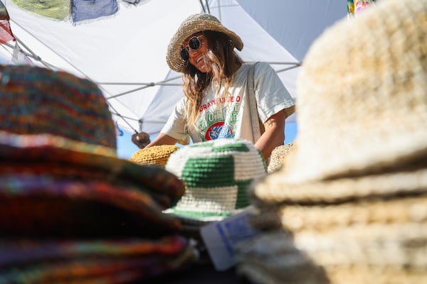 Bri Vandenberg organizes Sunny Life Hemp Hats at a retail stand at the SweetWater 420 Festival on Friday, April 17, 2026, at Shirley Clarke Franklin Park in Atlanta. (Abbey Cutrer/AJC)