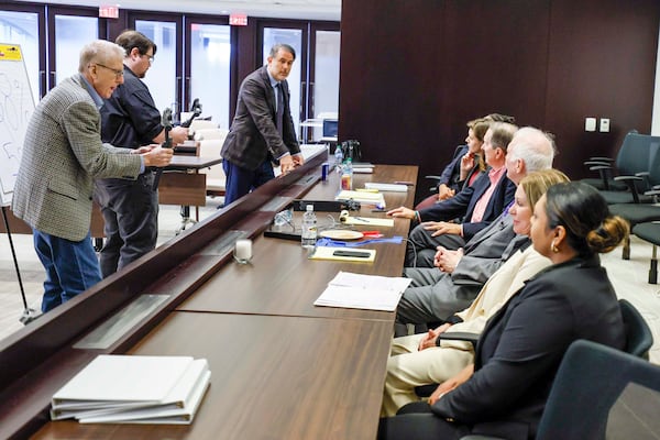 Atlanta criminal defense lawyer Jason Sheffield (center) addresses participants during the JurisPerfect Performance Lab workshop in late August at Alston & Bird's courtroom in Midtown. (Miguel Martinez/AJC)
