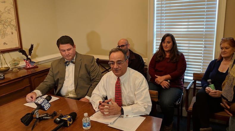 Jan. 11, 2019, Marietta – Lawyer Rob Madayag (seated left) with lawyer Mitch Skandalakis, speaking about bullying in Cobb County, with the parents of alleged victims seated behind.