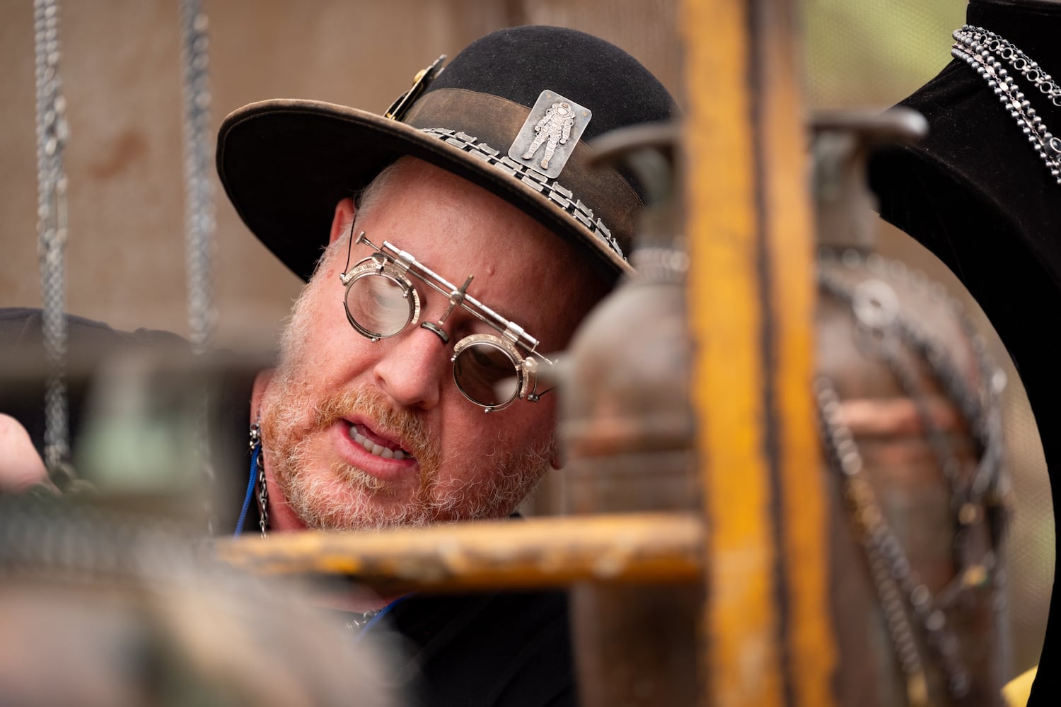 Artist Carlos Montanaro from Indio, Calif., shows a watch to a customer during the Atlanta Dogwood Festival at Piedmont Park on Saturday, April 11, 2026. (Ben Gray for the AJC)