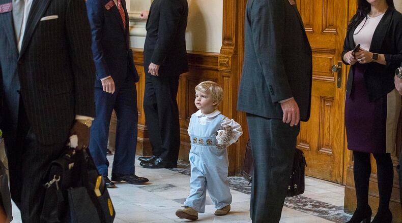 Two-year-old James Gambill of Cartersville navigates his way through Georgia lawmakers as he waits for his father, Rep. Matthew Gambill, to be sworn in.