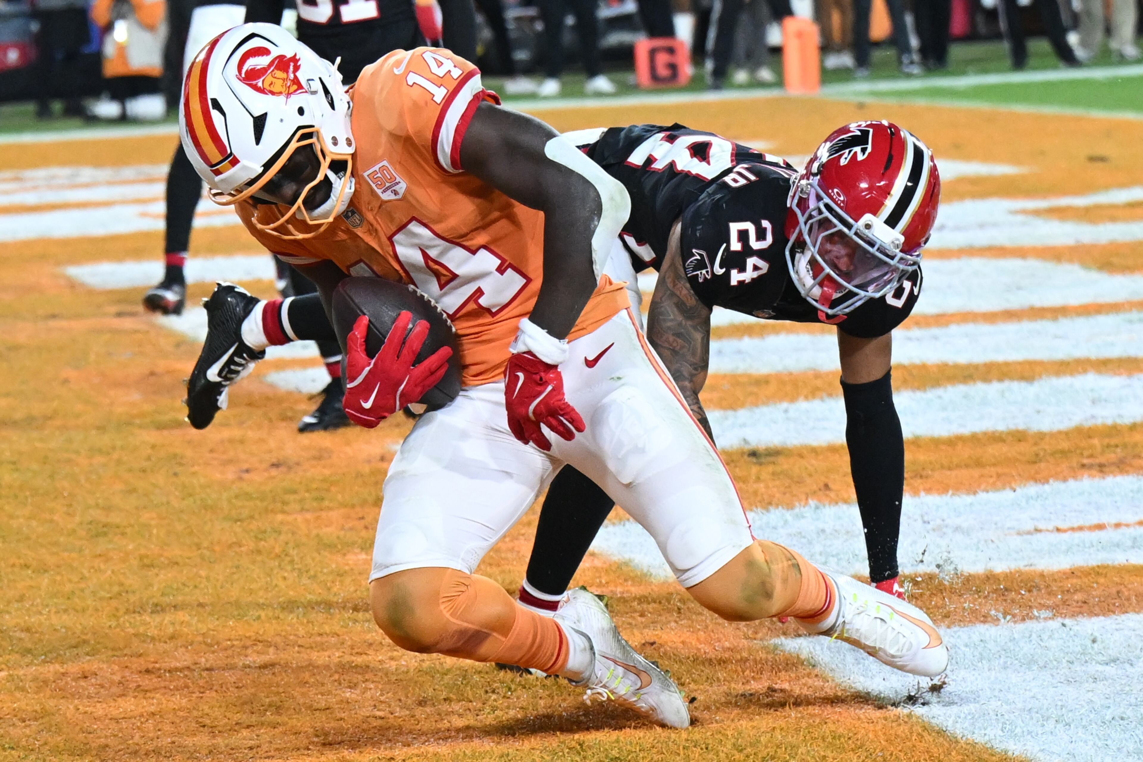 Tampa Bay Buccaneers wide receiver Chris Godwin Jr. (14) scores a touchdown against Atlanta Falcons cornerback A.J. Terrell Jr. (24) during the second half of an NFL football game, Thursday, Dec. 11, 2025, in Tampa, Fla. (AP Photo/Jason Behnken)
