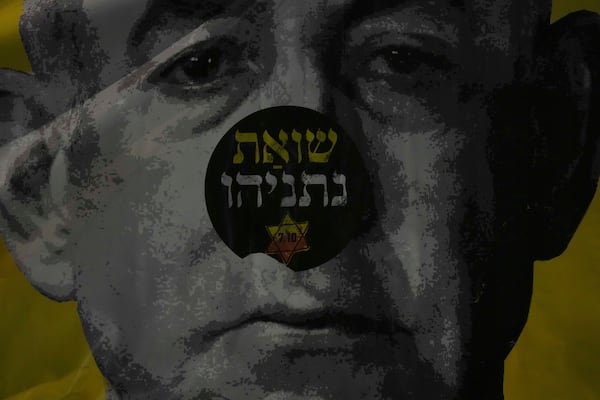 People take part in a protest demanding the immediate release of hostages held by Hamas in the Gaza Strip, in Tel Aviv, Israel, on Saturday, April 19, 2025. The poster says Netanyahu's holocaust. (AP Photo/Ariel Schalit)