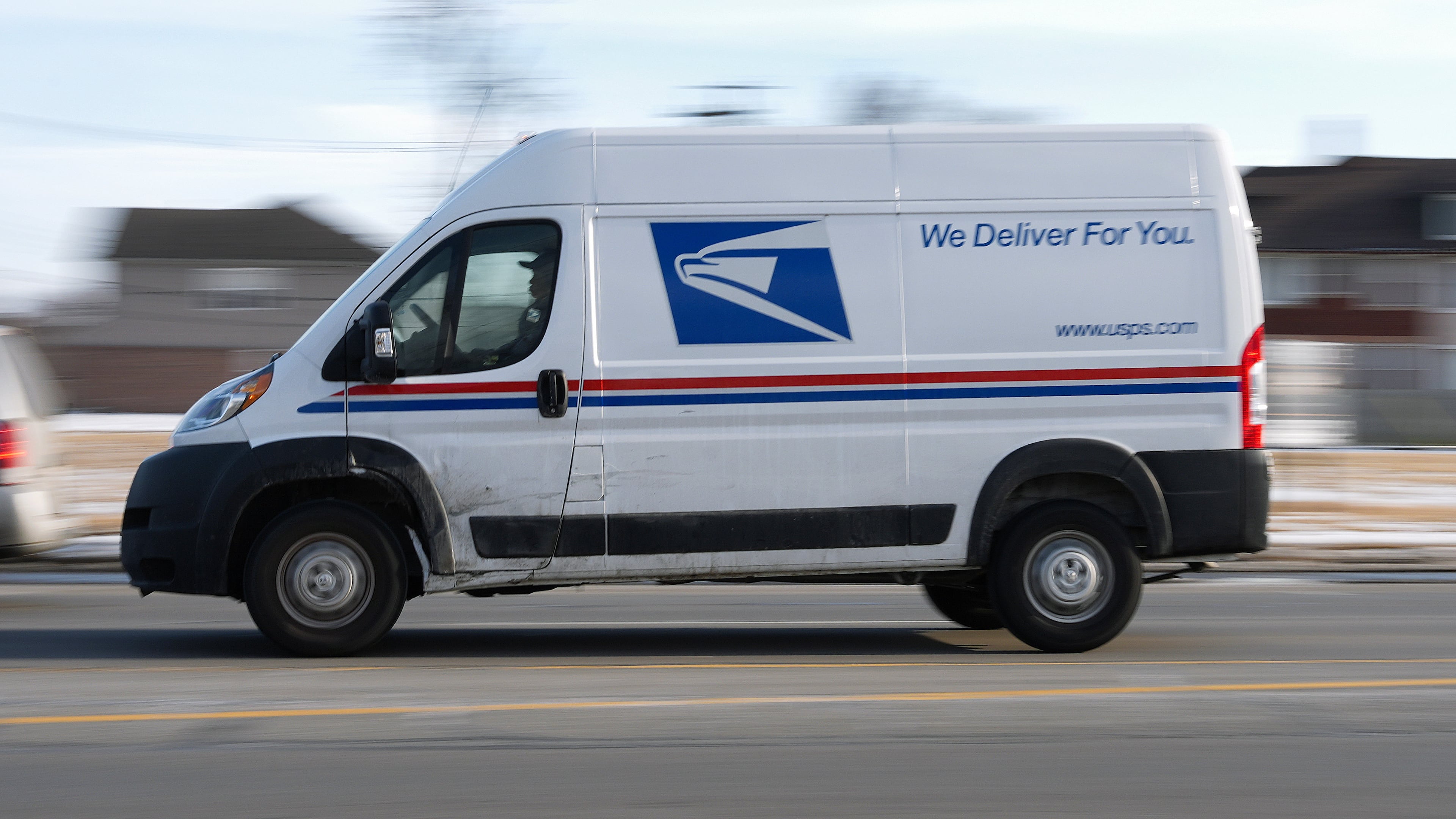 FILE - A United States Postal Service truck drives through Detroit, Feb. 24, 2025. (AP Photo/Paul Sancya, File)