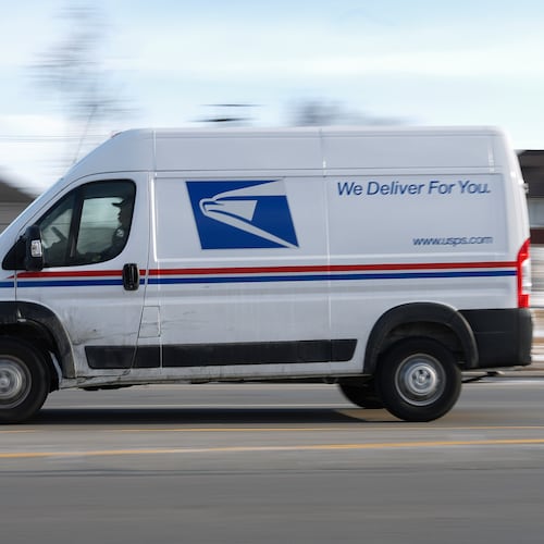 FILE - A United States Postal Service truck drives through Detroit, Feb. 24, 2025. (AP Photo/Paul Sancya, File)