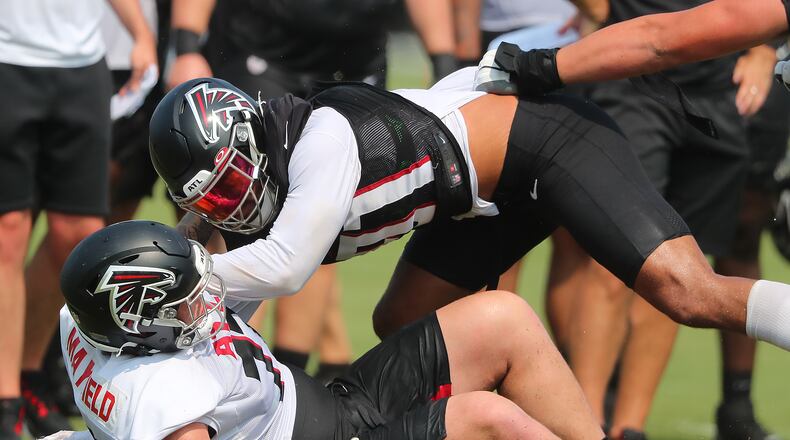 073121 Flowery Branch: Atlanta Falcons outside linebacker Jacob Tuioti-Mariner (top) levels rookie offensive lineman Jalen Mayfield at the line of scrimmage during a play on the third day of training camp practice on Saturday, July 31, 2021, in Flowery Branch. “Curtis Compton / Curtis.Compton@ajc.com”