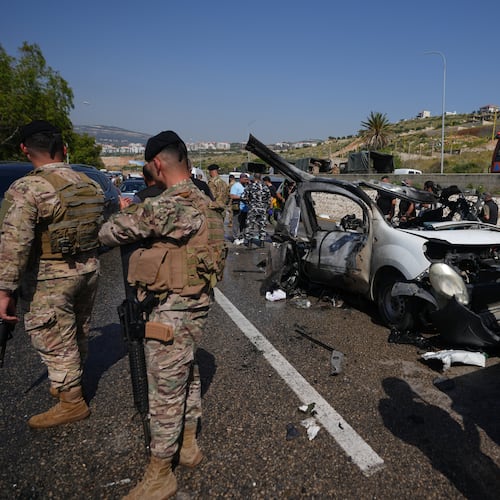 Security forces and emergency responders gather around a damaged vehicle at the scene of an Israeli airstrike that hit a car in the coastal town of Saadiyat, south of Beirut, Lebanon, Saturday, May 9, 2026. (AP Photo/Hassan Ammar)