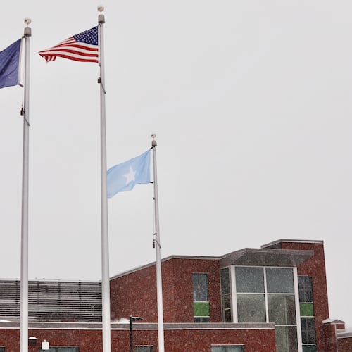 A Somali flag flies alongside the United States and Vermont flags outside the Winooski School District building Wednesday, Dec. 10, 2025, in Winooski, Vt. (AP Photo/Amanda Swinhart)