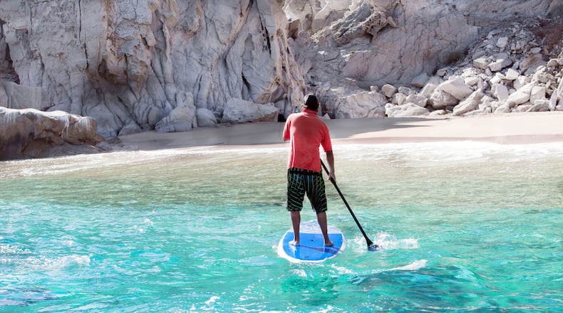Paddleboarding in turquoise waters of Cabo San Lucas.