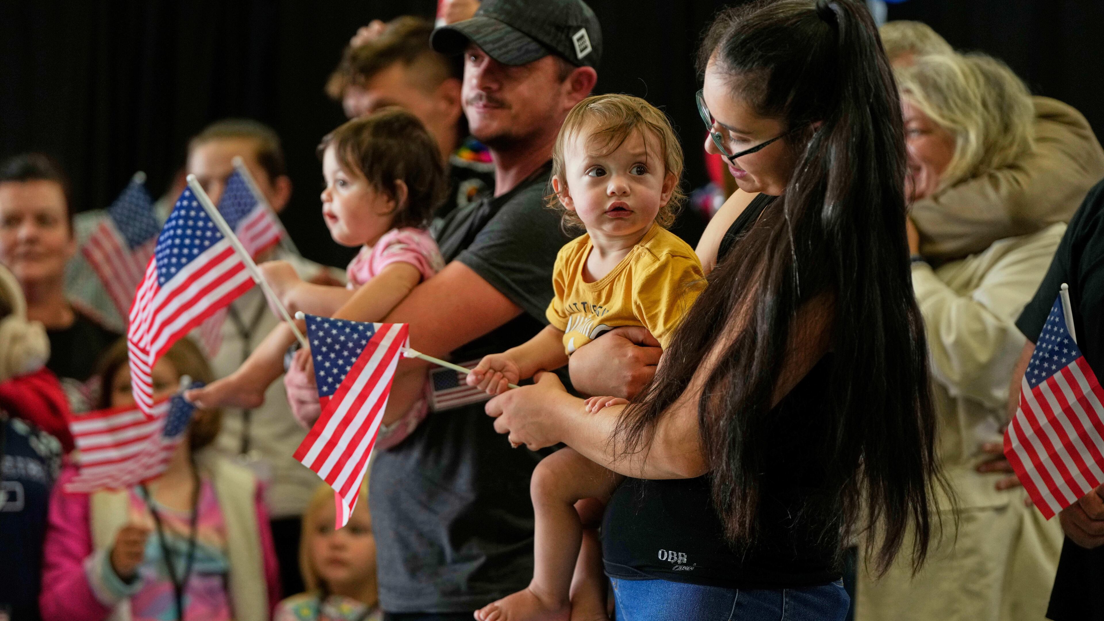 FILE - Afrikaner refugees from South Africa holding American flags arrive, May 12, 2025, at Dulles International Airport in Dulles, Va. (AP Photo/Julia Demaree Nikhinson, File)