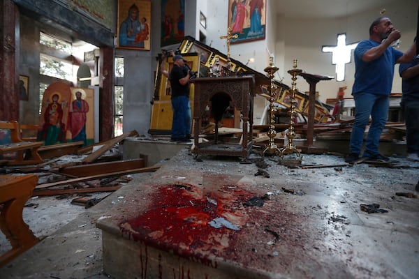 Syrian gather inside Mar Elias church where a suicide bomber detonated himself in Dweil'a in the outskirts of Damascus, Syria, June 22, 2025. (AP Photo/Omar Sanadiki)