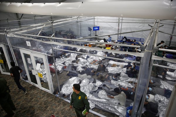 FILE - In this March 30, 2021 file photo, minors lie inside a pod at the Donna Department of Homeland Security holding facility, the main detention center for unaccompanied children in the Rio Grande Valley run by U.S. Customs and Border Protection (CBP), in Donna, Texas. (AP Photo/Dario Lopez-Mills,Pool, File)