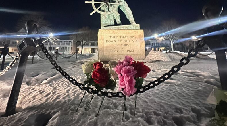 Flowers are seen placed at the Gloucester Fisherman's Memorial in Gloucester, Mass., after a fishing boat from port city went missing off the coast of Massachusetts with multiple people on board, Friday, Jan. 30, 2026. (AP Photo/Robert F. Bukaty)