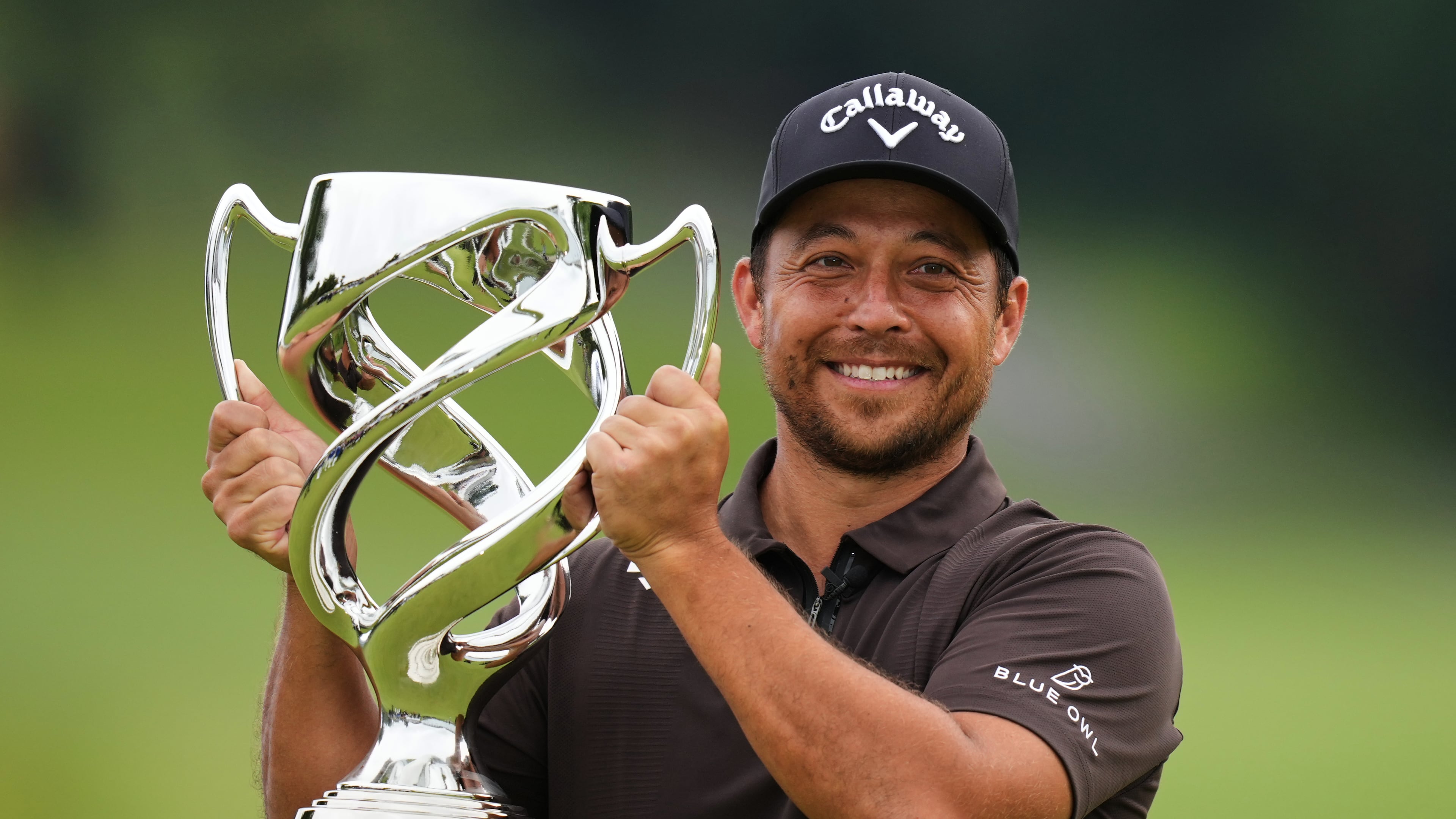 Xander Schauffele, of the U.S., poses for a photo with his trophy after he won the Baycurrent Classic golf tournament at the Yokohama Country Club in Yokohama, near Tokyo, Sunday, Oct. 12, 2025. (AP Photo/Hiro Komae)