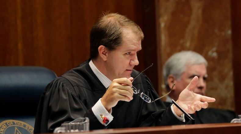 Texas Supreme Court Justice Don Willett, left, asks a question during oral arguments in Texas' latest school finance case at the state Supreme Court, Tuesday, Sept. 1, 2015, in Austin, Texas. Attorneys for more than 600 school districts suing Texas argue that the funding is inadequate and unfairly distributed, making it hard for students and schools to meet stringent academic standards. Attorney General Ken Paxton's office counters that, while not perfect, public education money meets state constitutional requirements for an efficient system providing a "general diffusion of knowledge."(AP Photo/Eric Gay)