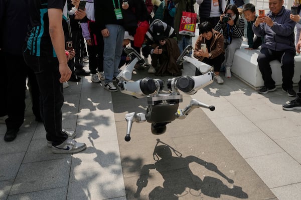 A robot demonstrates a backflip after the Humanoid Robot Half-Marathon held in Beijing on Saturday, April 19, 2025. (AP Photo/Ng Han Guan)