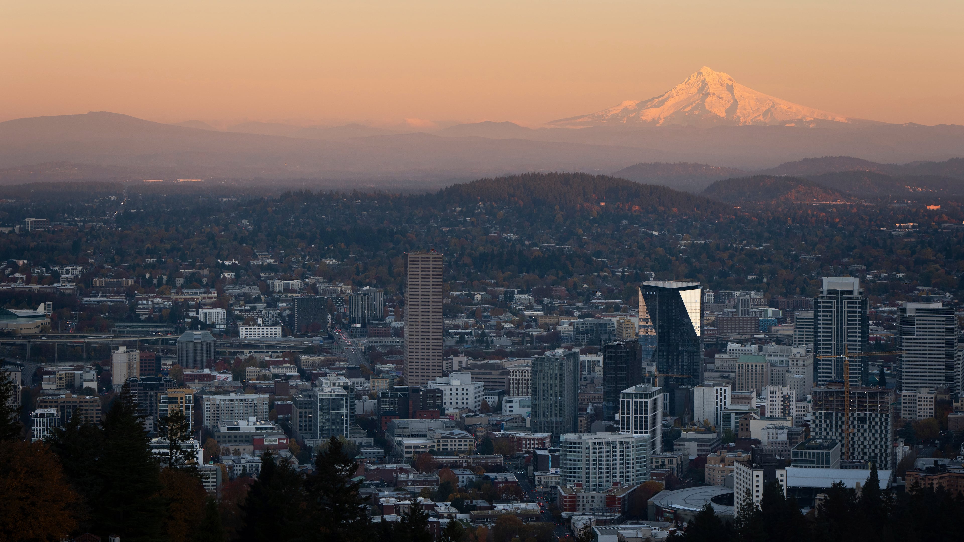 FILE - With Mount Hood in the background, the sun sets over downtown Portland, Ore., on Wednesday, Nov. 6, 2024. (AP Photo/Jenny Kane, File)
