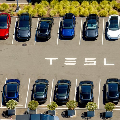 FILE - Tesla vehicles line a parking area at the company's Fremont, Calif., factory on Tuesday, Aug. 5, 2025. (AP Photo/Noah Berger, File)