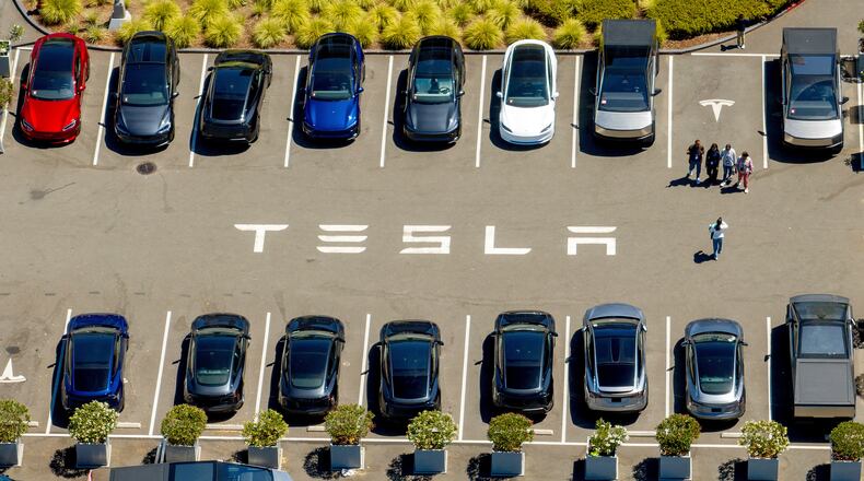 FILE - Tesla vehicles line a parking area at the company's Fremont, Calif., factory on Tuesday, Aug. 5, 2025. (AP Photo/Noah Berger, File)