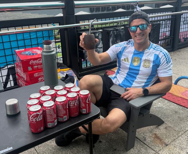 Argentina supporter Pitu Blazquez takes in the view Tuesday at Underground Atlanta. The aerial artist said he saved up for four years to cheer on his side in America. (Alex Nettles/AJC)