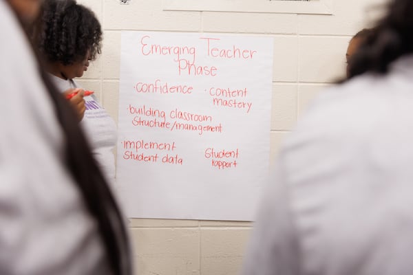 Residents work in groups to break down what they expect to accomplish within the five phases of the IGNITE Teacher Residency Program at Stone Mountain High School on Thursday. July 23, 2026. (Estela Muñoz/AJC)