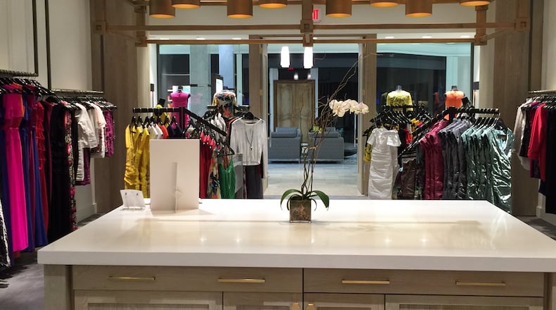 A large island anchors the Nicole Miller boutique at Phipps Plaza creating a warm, casual environment.