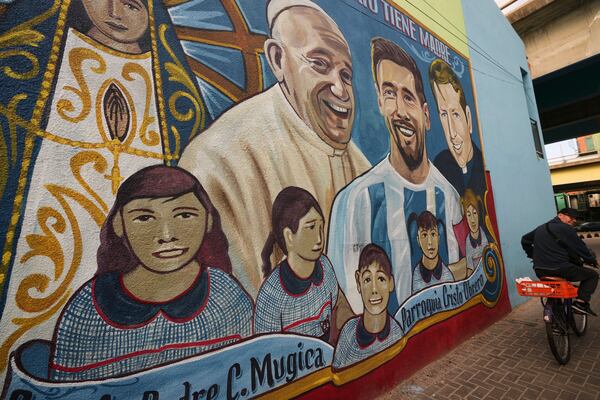 The late Pope Francis is depicted on a mural alongside soccer player Lionel Messi at the Carlos Mugica neighborhood in Buenos Aires, Argentina, Monday, April 21, 2025. (AP Photo/Rodrigo Abd)
